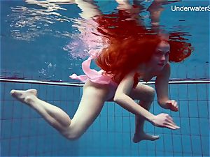 ginger-haired Simonna flashing her figure underwater